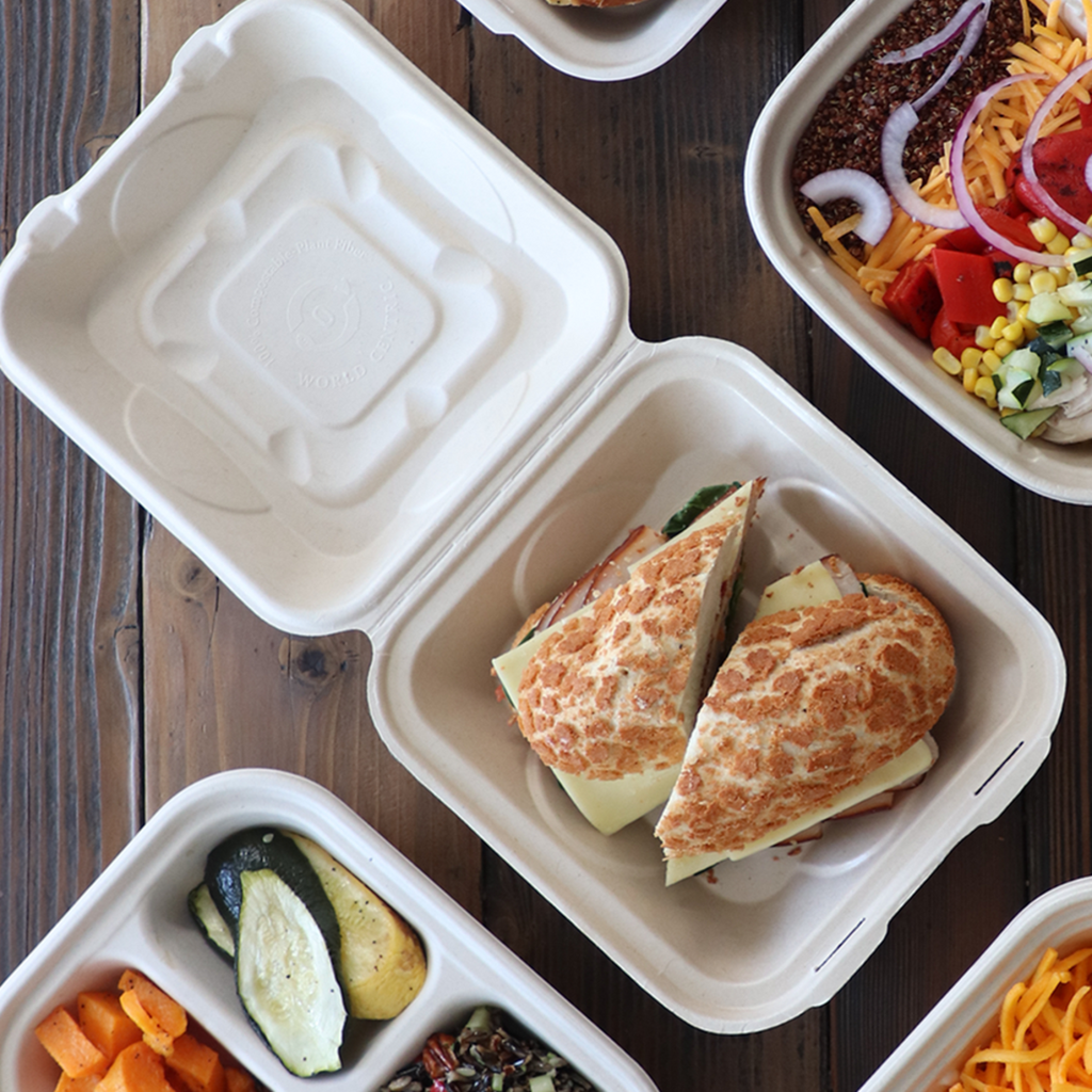 World Centric Compostable 9x9x3 Fiber Clamshell Container with a bio-based lining. Shown with take-out food.