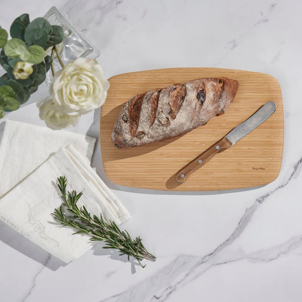 Organic Bamboo Medium Classic Cutting Board shown with Bread and Knife