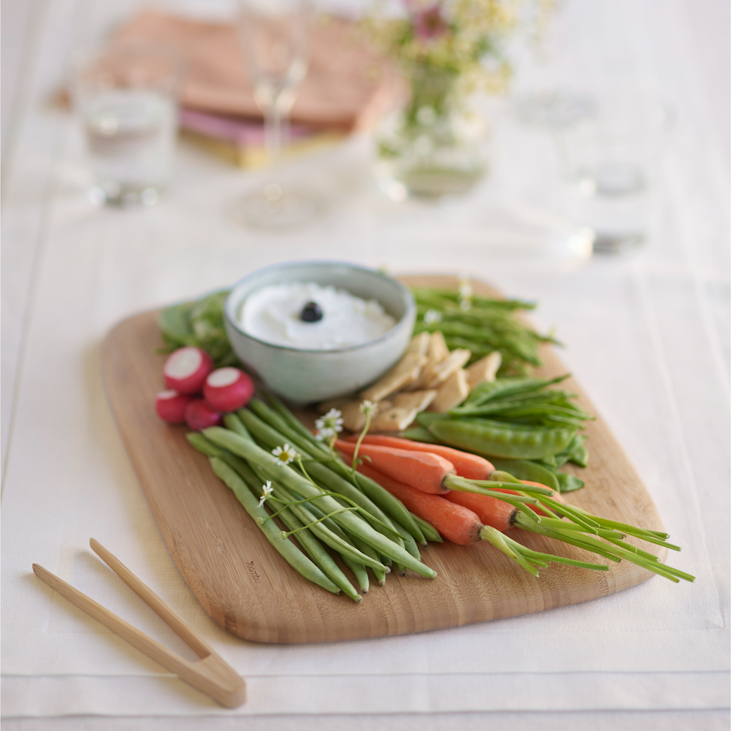 Organic Bamboo Large Cutting Board shown with veggies and dip