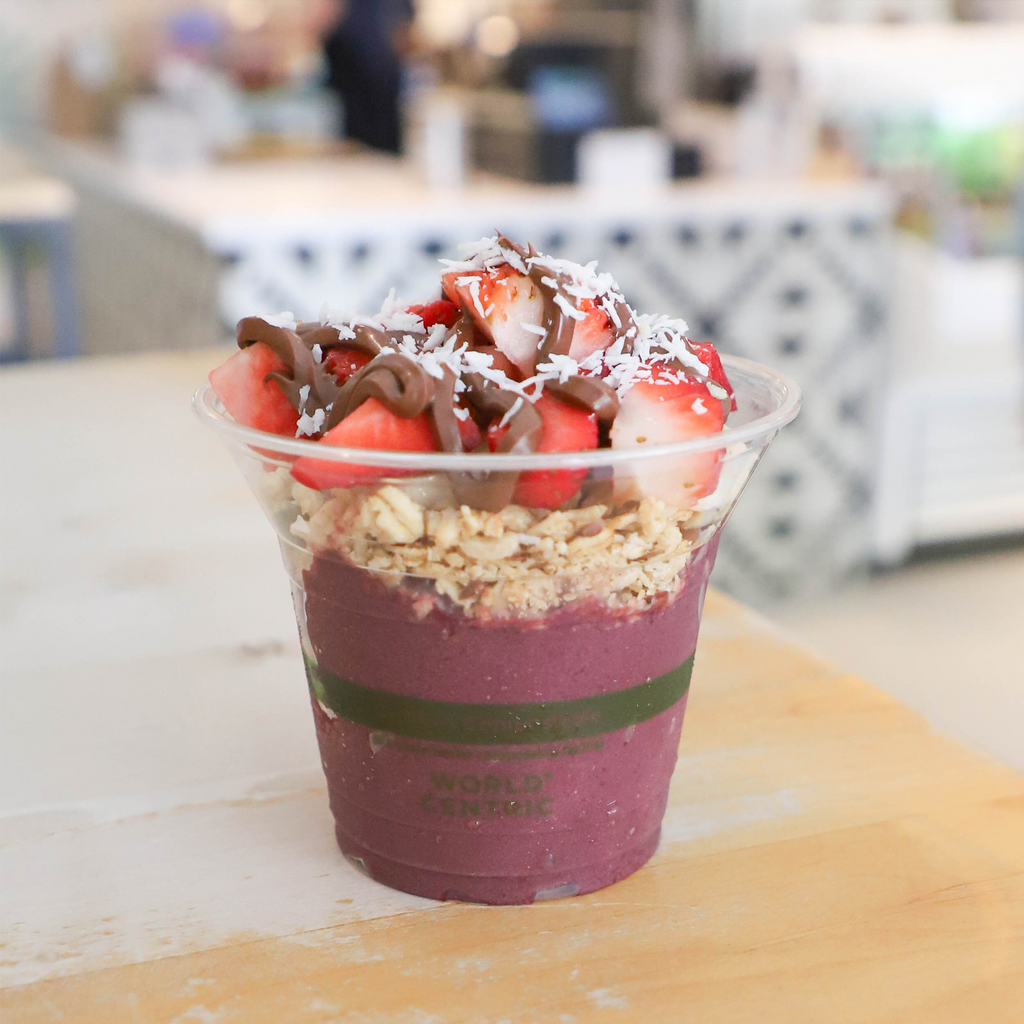 Açaí bowl with strawberries and granola in a World Centric Compostable 10 oz Clear cold Cup