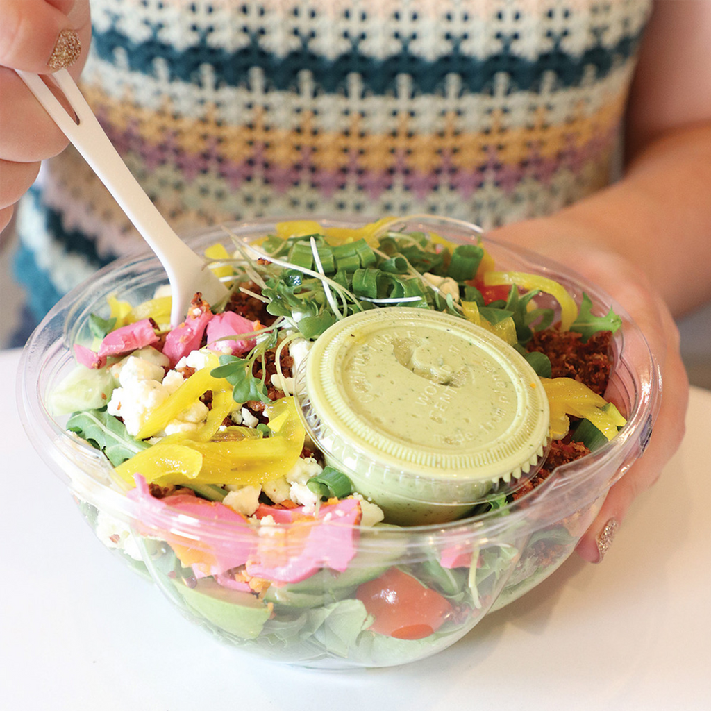 World Centric Compostable PLA 2 oz Clear Portion Cup shown with dressing and salad