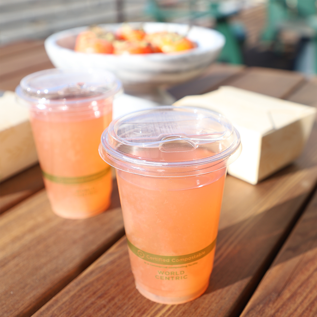 World Centric Compostable PLA Sip Lid for 9Q-24 oz Cold Cups, shown with beverage