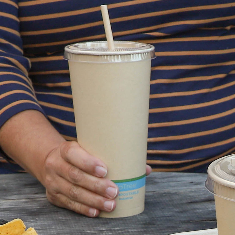 Person holding World Centric 22 oz NoTree Paper Cold Cup with Lid