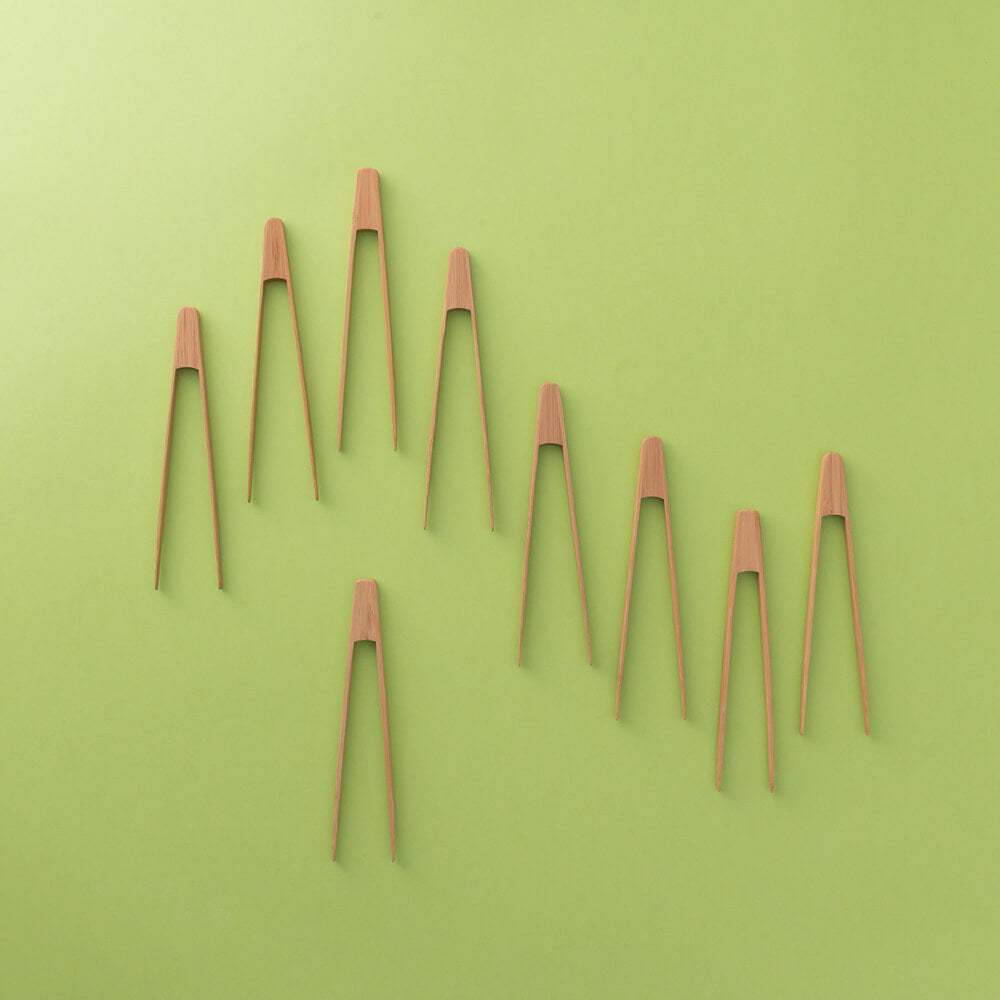 Bambu Home Organic Bamboo Tiny Tongs shown with Green Background